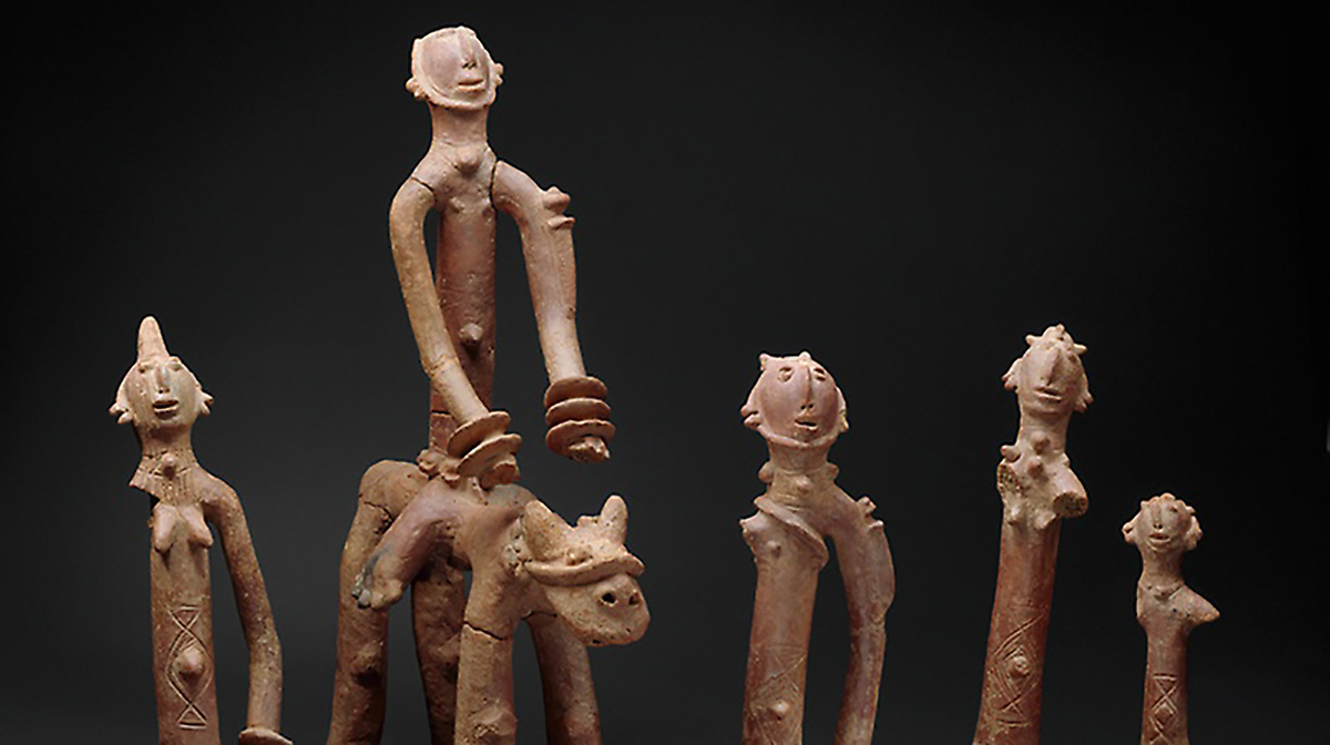 Four elongated terracotta people surround a fifth figure riding a horse.